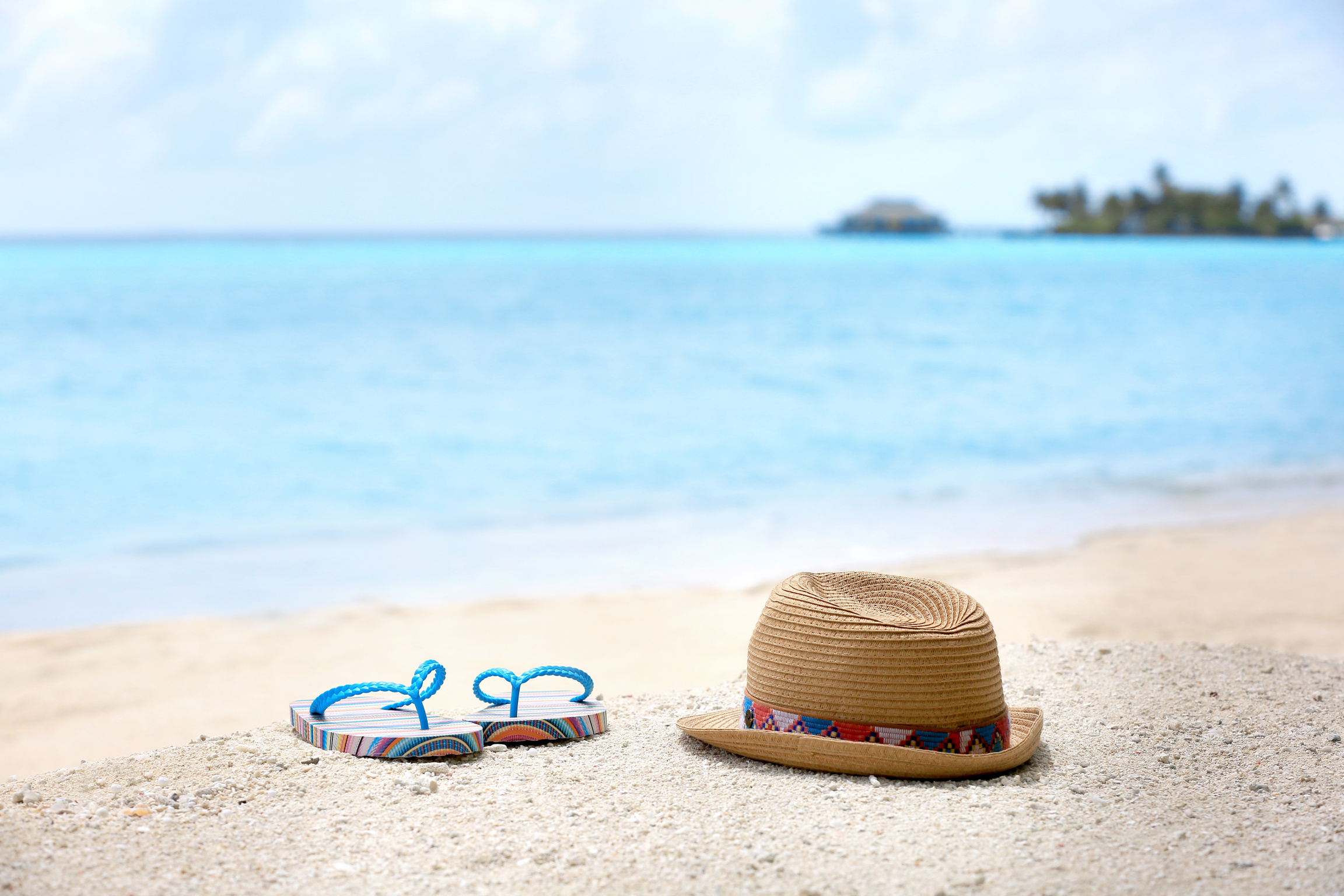 Flip-Flops and Hat on Sea Beach. Summer Vacation Concept